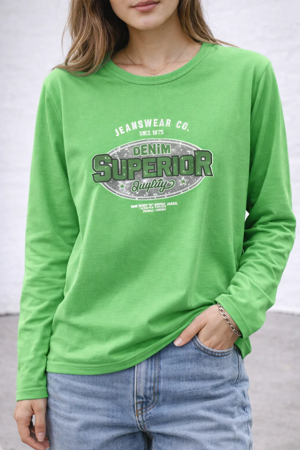 Woman wearing green long sleeve shirt with denim superior quality graphic and blue jeans