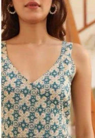Woman wearing a sleeveless V-neck dress with blue floral geometric print