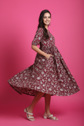 Maroon floral midi dress showing flare and movement - flowing skirt with side pockets
