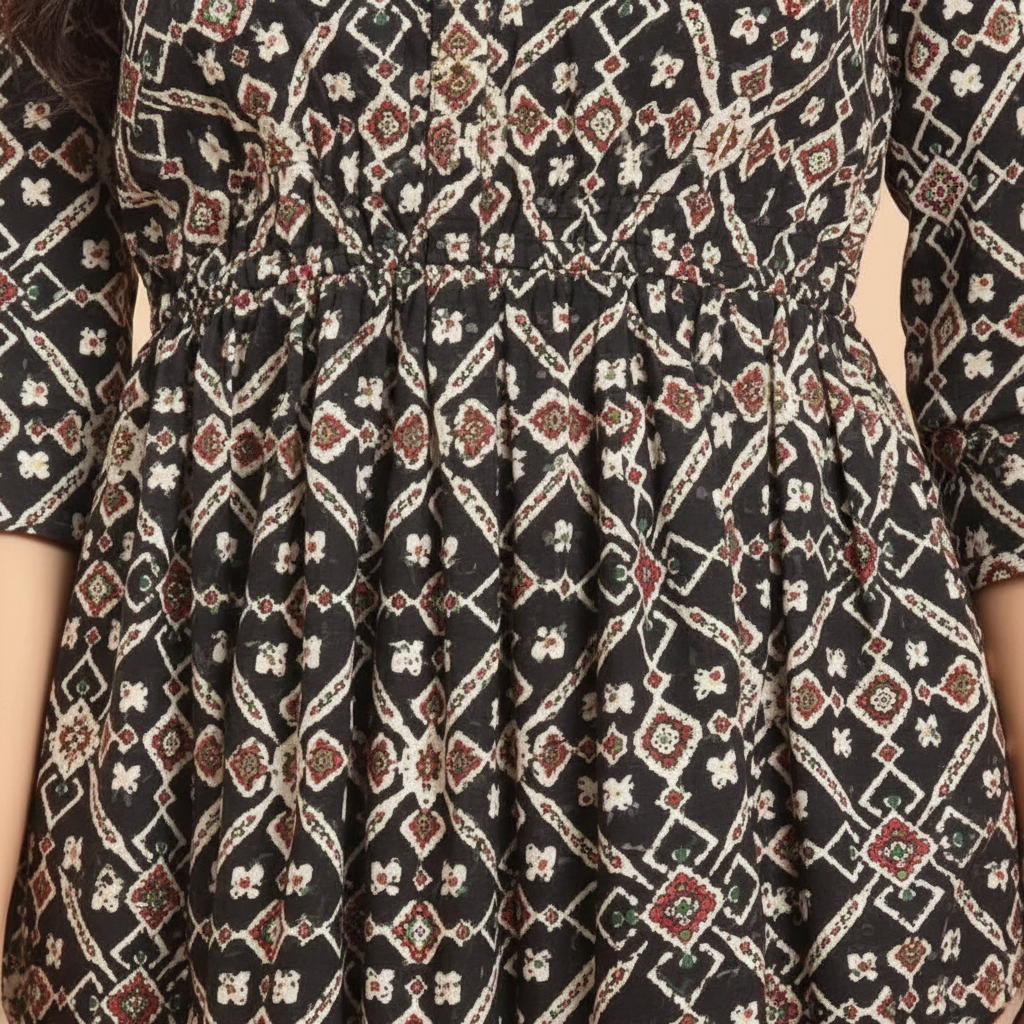 Close-up detail of black white geometric diamond print and gathered waist