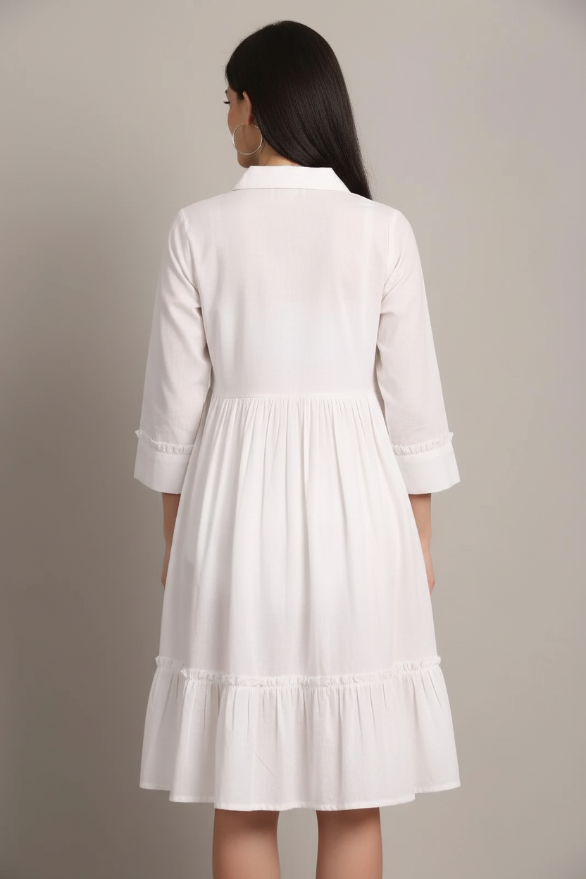 White tiered dress back view showing gathered waist and flowing tiered skirt