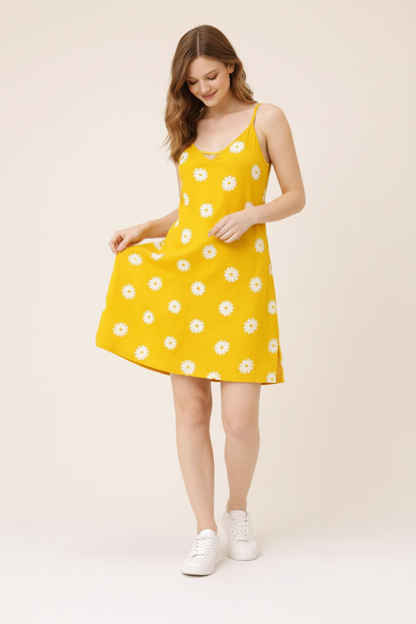Model touching yellow daisy dress and looking at fabric quality