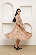 Peach floral midi dress showing flare and movement - flowing tiered skirt