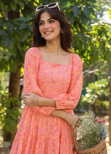 Woman in a pink floral dress with puff sleeves holding a basket of flowers outdoors